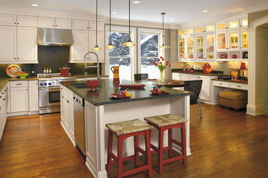 Inspiration for a large transitional l-shaped dark wood floor and brown floor eat-in kitchen remodel in Grand Rapids with an undermount sink, recessed-panel cabinets, white cabinets, quartzite countertops, black backsplash, stainless steel appliances and an island