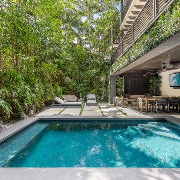 Backyard of a Minimalist Mansion With Pool, Greenery and Luxury Furniture