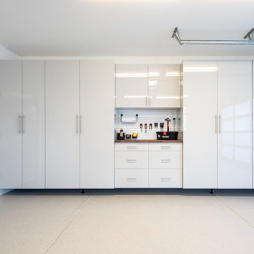 Sleek White Garage Cabinets with Integrated Workstation