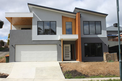 Modelo de fachada de casa multicolor minimalista a niveles con tejado plano, tejado de metal y revestimientos combinados
