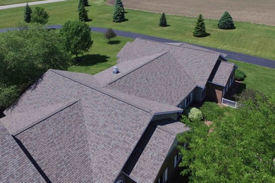 Huge traditional two-story brick exterior home idea in Minneapolis with a shingle roof