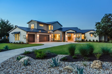 Example of a large trendy white two-story mixed siding exterior home design in Austin with a hip roof