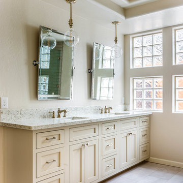 Grey/tan bathroom vanity with her and hers sinks, built-in counter with dresser
