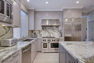 Inspiration for a mid-sized transitional light wood floor eat-in kitchen remodel in Los Angeles with a single-bowl sink, shaker cabinets, gray cabinets, quartz countertops, gray backsplash, stainless steel appliances and an island