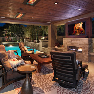 На фото: большой дворик на заднем дворе в современном стиле с местом для костра, мощением тротуарной плиткой и навесом с