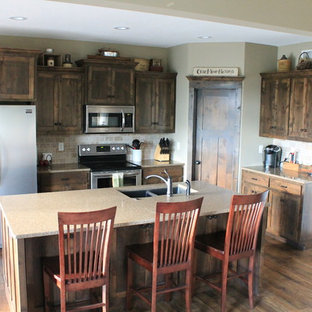 Craftsman kitchen pantry ideas - Inspiration for a craftsman medium tone wood floor kitchen pantry remodel in Kansas City with an undermount sink, shaker cabinets, dark wood cabinets, quartz countertops, beige backsplash, stone tile backsplash, stainless steel appliances and an island