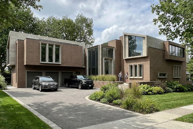 Huge trendy multicolored three-story brick house exterior photo in DC Metro with a metal roof and a black roof