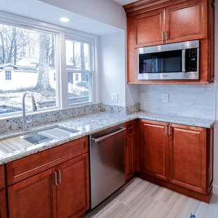 Design ideas for a mid-sized traditional u-shaped eat-in kitchen in DC Metro with an undermount sink, raised-panel cabinets, brown cabinets, quartz benchtops, white splashback, glass tile splashback, stainless steel appliances, ceramic floors, a peninsula, beige floor and multi-coloured benchtop.