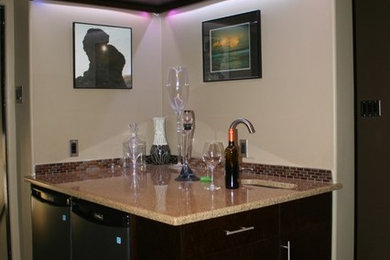 Photo of a mid-sized transitional single-wall wet bar in Edmonton with an undermount sink, granite benchtops and medium hardwood floors.