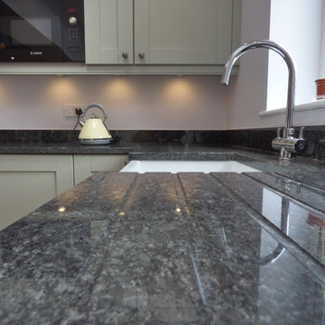 sage green painted shaker in large open plan kitchen