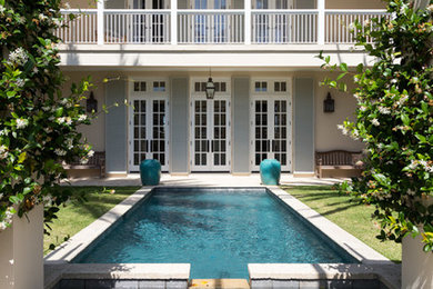 Inspiration for a large contemporary beige two-story exterior home remodel in Miami