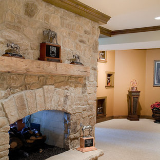 Photo of a large rural walk-out basement in Chicago with carpet, a standard fireplace and a stone fireplace surround.