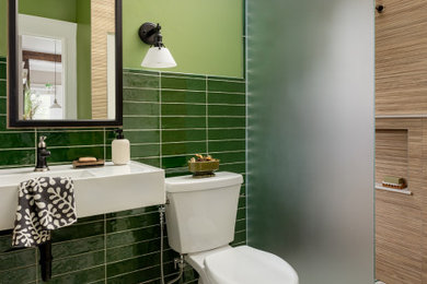 Example of a small danish 3/4 green tile and ceramic tile ceramic tile and single-sink bathroom design in Baltimore with a two-piece toilet, green walls, a wall-mount sink, a niche and a floating vanity