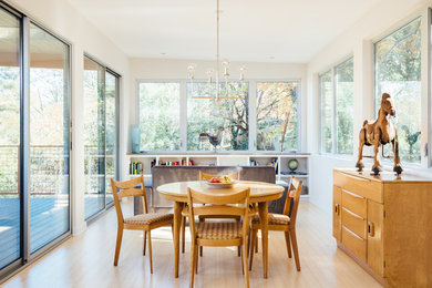 Design ideas for a modern dining room in Houston with white walls and bamboo floors.