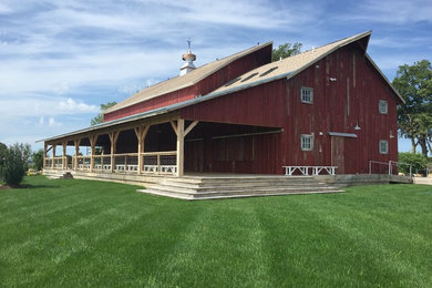 Inspiration for a large rustic detached barn remodel in Other