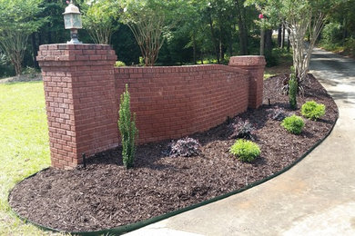 Photo of a large traditional full sun front yard mulch landscaping in Atlanta for summer.