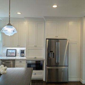 White inset cabinetry with walnut custom accents