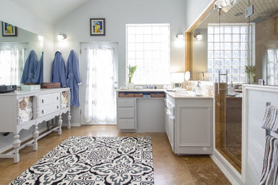 Corner shower - large transitional 3/4 beige tile ceramic tile and beige floor corner shower idea in Oklahoma City with raised-panel cabinets, white cabinets, gray walls, an undermount sink and a hinged shower door