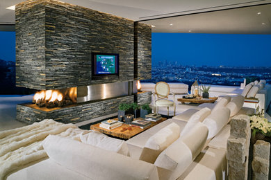 Living room - huge modern open concept living room idea in Los Angeles with a two-sided fireplace