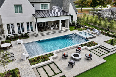 Example of a mid-sized transitional concrete paver and rectangular pool landscaping design in Nashville