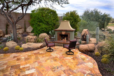 This is an example of a huge southwestern backyard landscaping in Phoenix with a fire pit.