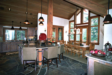 Inspiration for a large rustic l-shaped slate floor eat-in kitchen remodel in Sacramento with a drop-in sink, recessed-panel cabinets, medium tone wood cabinets, granite countertops, beige backsplash, ceramic backsplash, stainless steel appliances and an island