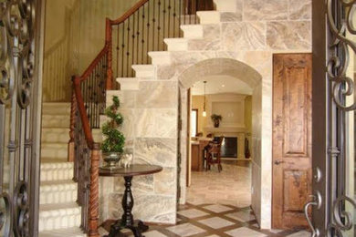 Inspiration for a large mediterranean concrete l-shaped mixed material railing staircase remodel in Orange County with concrete risers