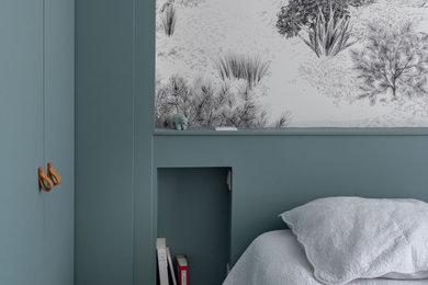 Inspiration pour une chambre parentale minimaliste de taille moyenne avec un mur bleu, parquet clair et du papier peint.