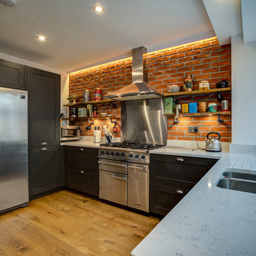 Traditional Kitchen featuring brick slip wall and steampunk shelves
