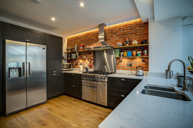 Traditional Kitchen featuring brick slip wall and steampunk shelves