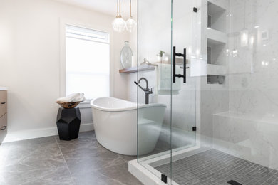 Example of a large trendy master white tile and porcelain tile porcelain tile, gray floor and double-sink bathroom design in Vancouver with flat-panel cabinets, brown cabinets, a wall-mount toilet, white walls, a drop-in sink, quartzite countertops, a hinged shower door, white countertops and a floating vanity