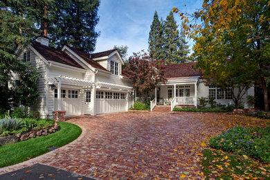 Example of a mid-sized classic white two-story concrete fiberboard exterior home design in San Francisco with a shingle roof