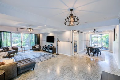 Large contemporary open concept living room in Brisbane with panelled walls.