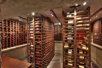 Example of a huge mountain style slate floor wine cellar design in New York
