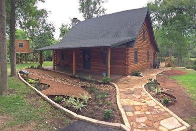 Design ideas for a mid-sized rustic partial sun front yard stone garden path in Houston.