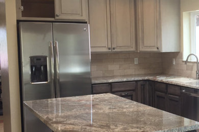 Inspiration for a mid-sized southwestern u-shaped ceramic tile and beige floor eat-in kitchen remodel in Phoenix with a double-bowl sink, raised-panel cabinets, gray cabinets, granite countertops, gray backsplash, stone tile backsplash, stainless steel appliances and an island