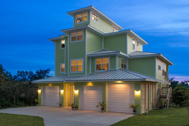 Beach style three-story exterior home photo in Tampa with a hip roof