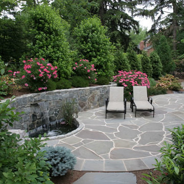 Flagstone Patio with Sheer Descent Water Feature and Rose Bushes