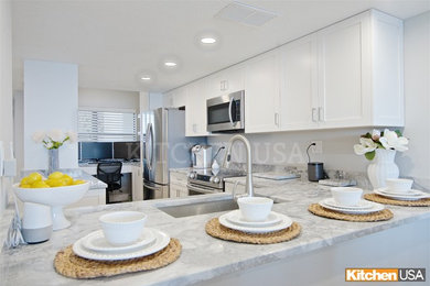 Example of a mid-sized u-shaped eat-in kitchen design in Jacksonville with an undermount sink, shaker cabinets, white cabinets, quartzite countertops, stainless steel appliances, an island and gray countertops