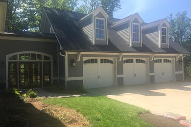 Example of a large classic gray two-story wood house exterior design in Atlanta with a clipped gable roof and a shingle roof