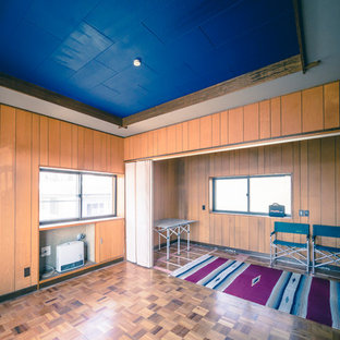 Photo of a small enclosed home cinema in Other with brown walls, plywood flooring and brown floors.