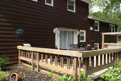 Mid-sized cottage backyard deck photo in Bridgeport with a roof extension