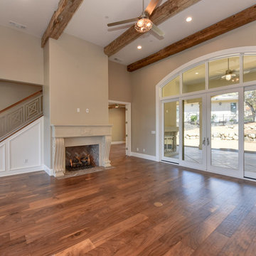 Family room with hand selected 100 year old antique beams contrasted with an ind
