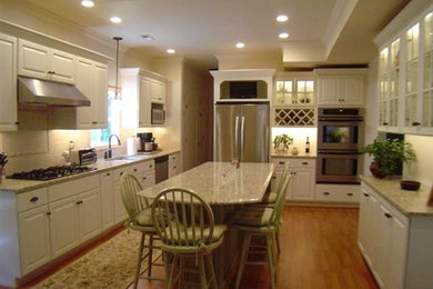Inspiration for a mid-sized transitional eat-in kitchen remodel in Richmond with white cabinets and an island