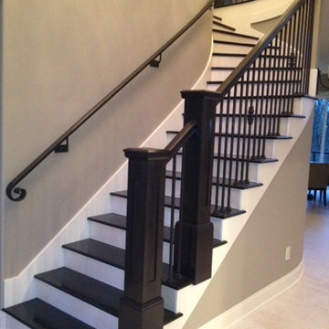 Interior Transitional Staircase with Wrought Iron Balusters