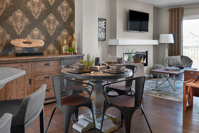 Dining room - contemporary dining room idea in Edmonton with beige walls and a standard fireplace