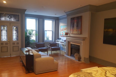 Living room - small traditional formal and open concept medium tone wood floor and brown floor living room idea in Philadelphia with white walls, a standard fireplace, a stone fireplace and no tv
