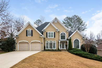 Large contemporary beige two-story stucco exterior home idea in Atlanta