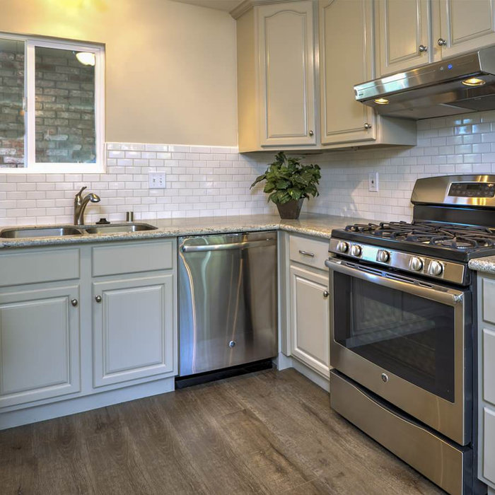 Example of a classic kitchen design in San Francisco with gray cabinets, granite countertops, white backsplash, subway tile backsplash, stainless steel appliances and an undermount sink