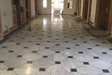 Example of a large classic marble floor and white floor vestibule design in London